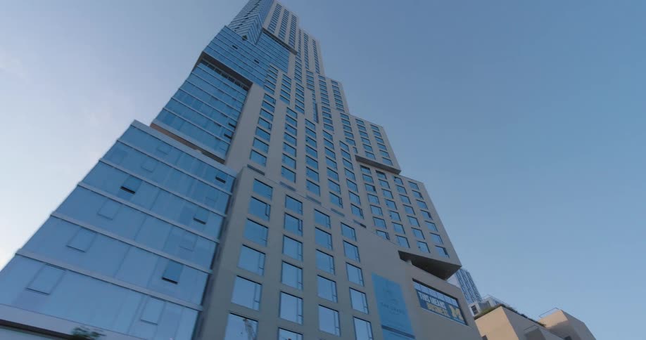 Tall modern highrise buildings stretche skyward against a clear blue sky