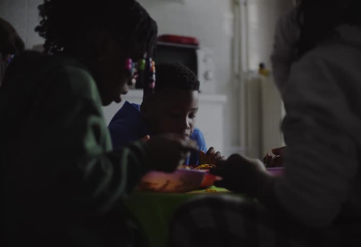 Group of people sitting around a table eating pasta
