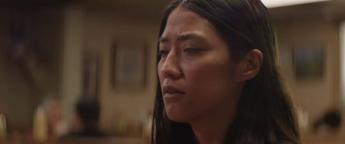 The video shows a woman with dark hair looking intently with a serious expression and a watermark for filmsupply is visible across the frame the background is blurred suggesting the focus is on her face