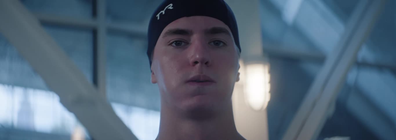The swimmer is standing in the building