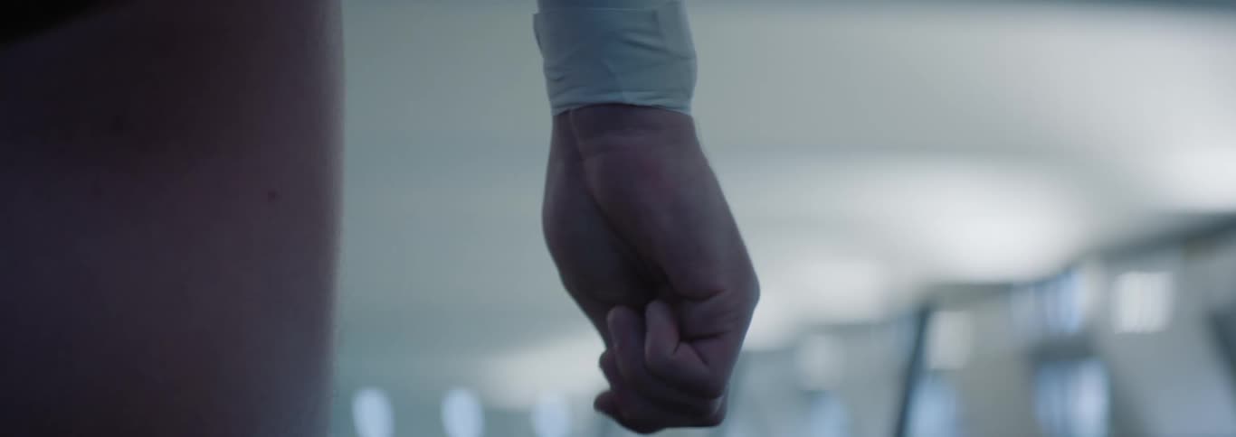 Person squeezing fingers of hand