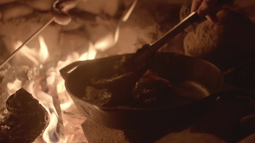 A person cooking on a skillet