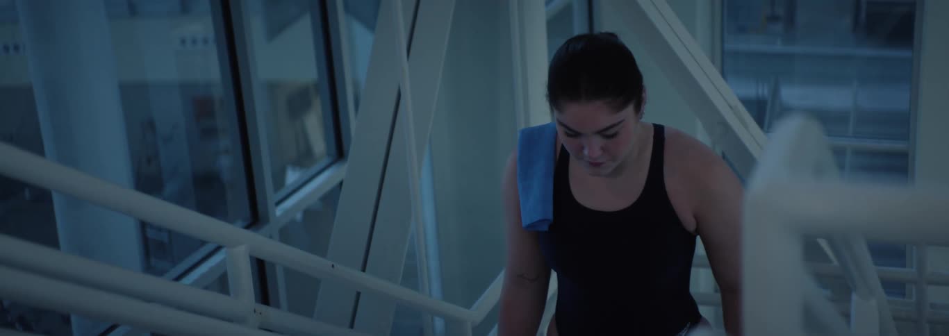 Woman in swimming costume walking up the stairs