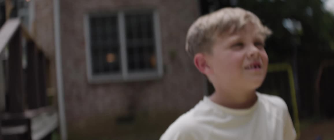 One of the children looks shocked in the yard