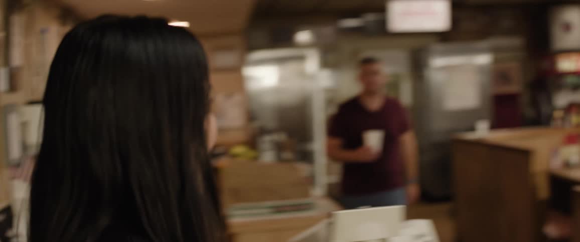 Woman with a happy expression walking into a diner