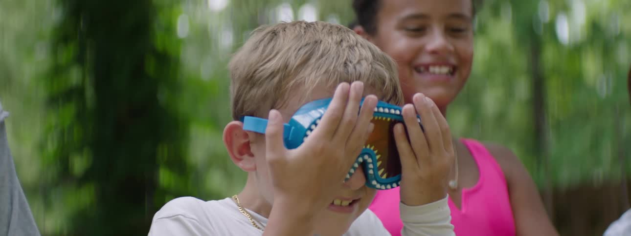 Boy putting his hand on his face while wearing glasses
