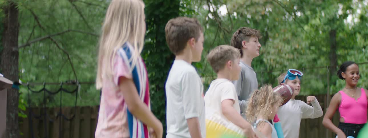 Kids have a pool party at midday cheering each other up