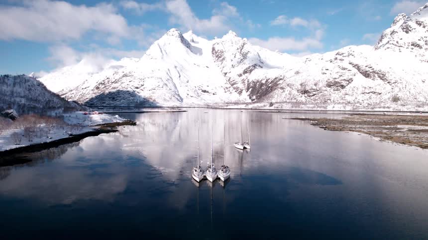 Boats are still in the water by the mountains