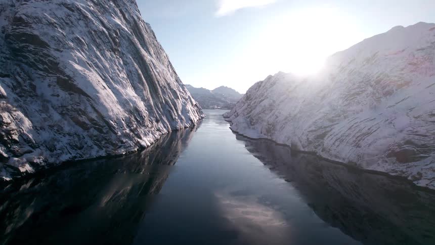 The sun reflects on the river water that runs through the mountains