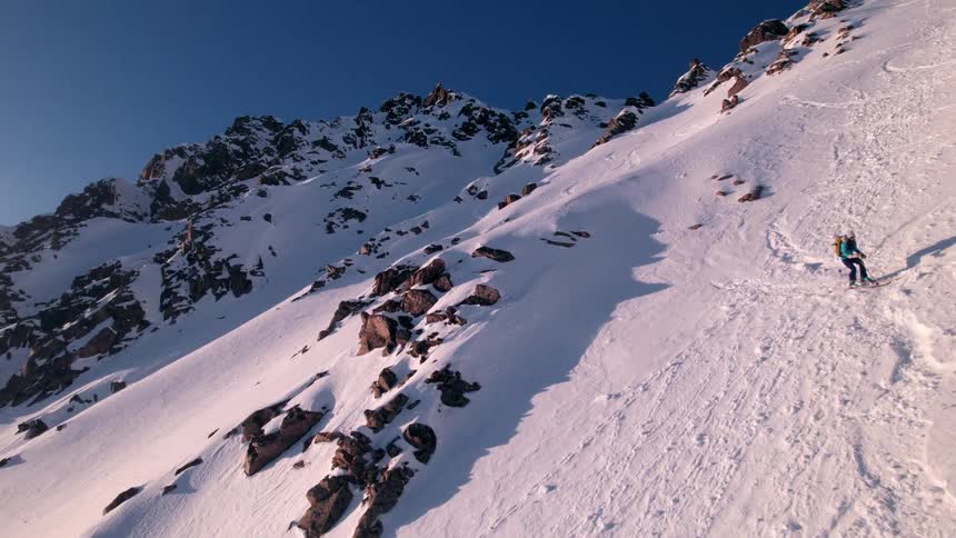 Person snowboarding on a snow covered mountain