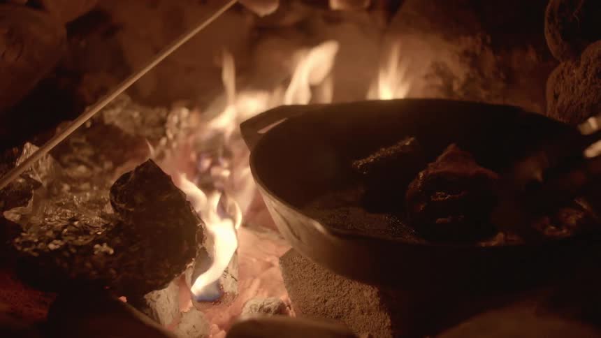 A person cooking on a skillet