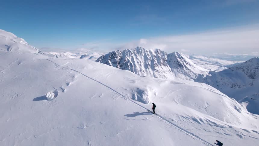 The people are climbing up the steep snow covered mountain