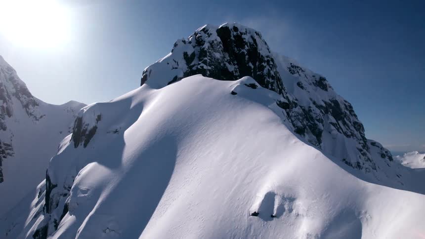 Snowcovered mountain against a cloudless blue sky