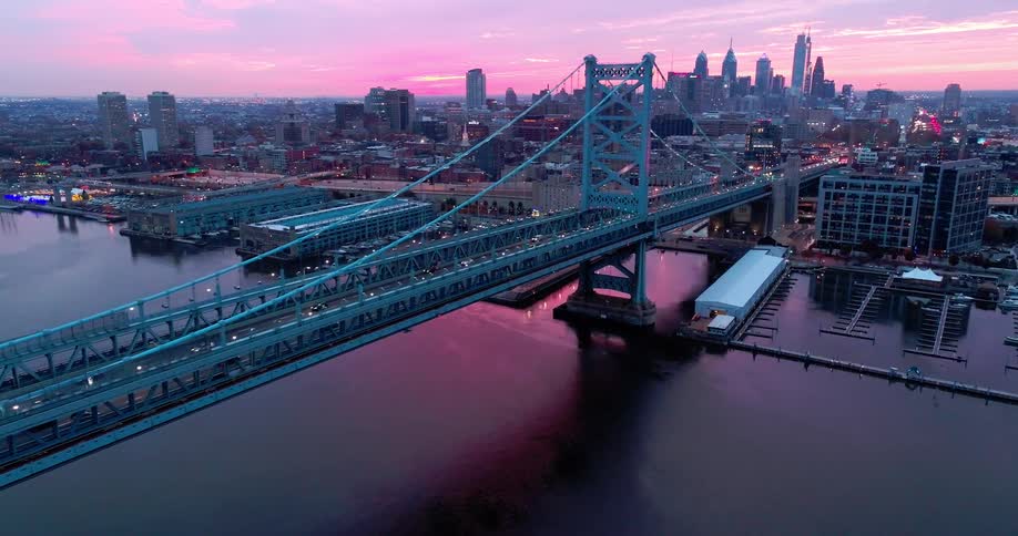 Heavy traffic is moving over the large bridge in the city