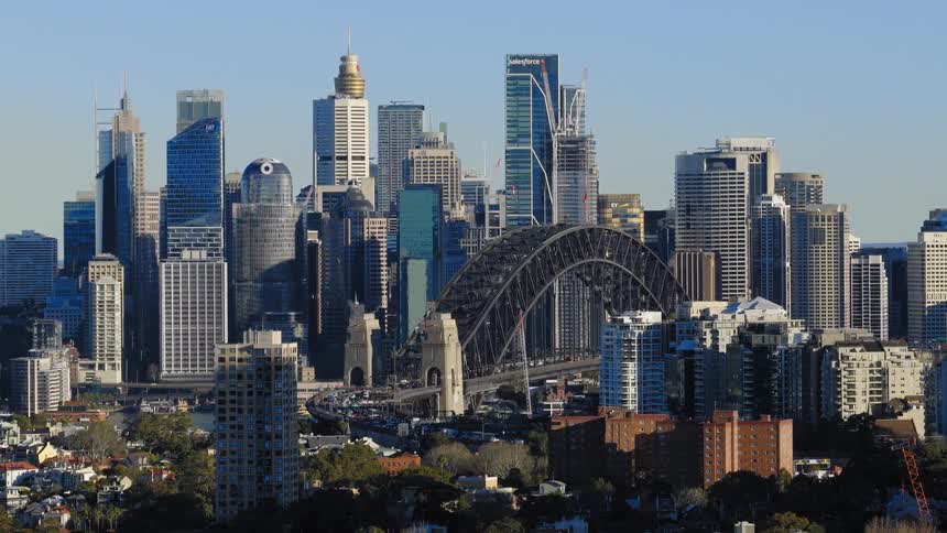 Iconic bridge set against a modern city skyline in daylight