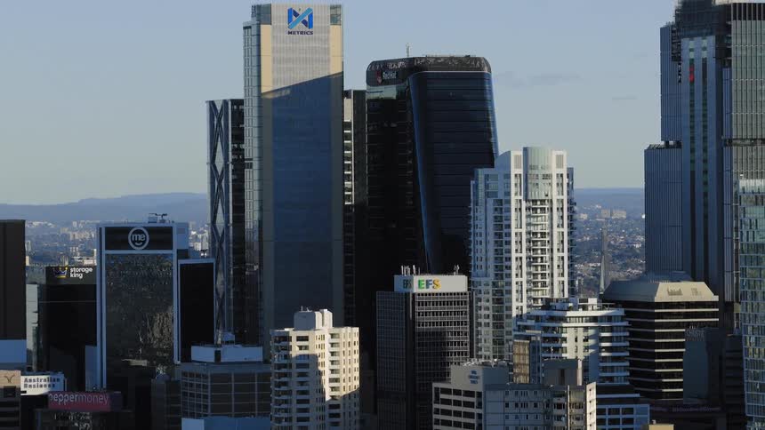 Tall skyscrapers dominate a modern city skyline under clear daylight