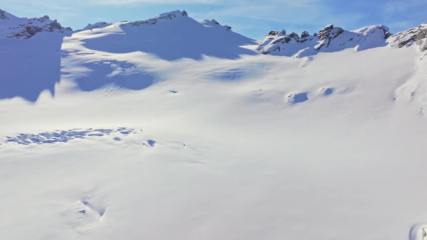 Snow covered mountain landscape under clear blue sky