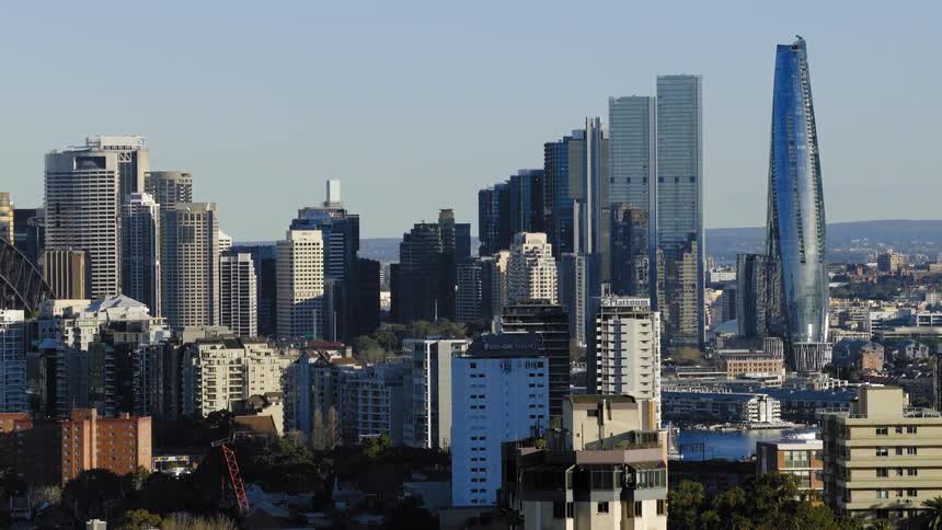 A city skyline against a blue sky