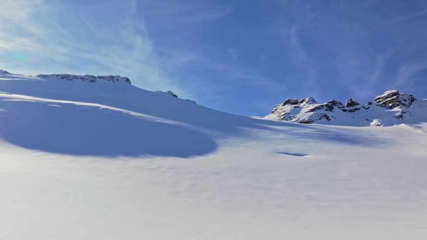 Landscape of snowcapped mountains against a blue sky