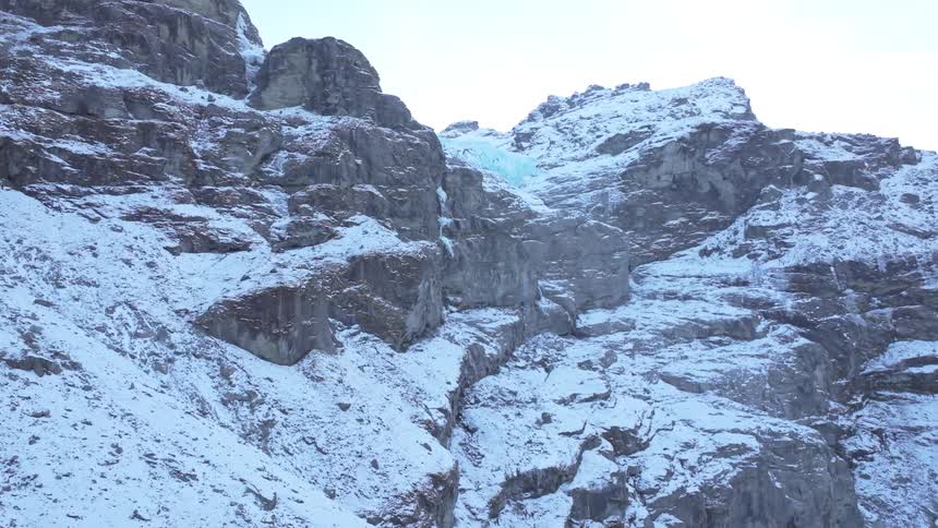 The tall mountain range is jagged and covered with light snow