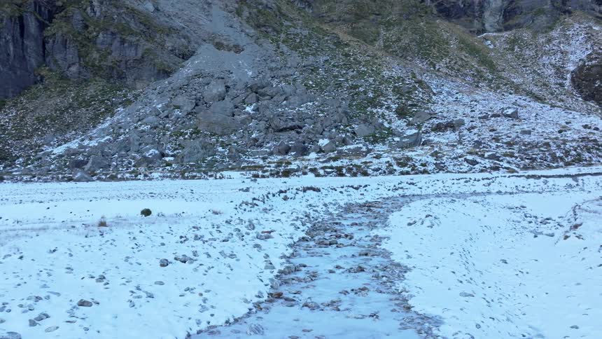 Snow is on the ground around the mountain