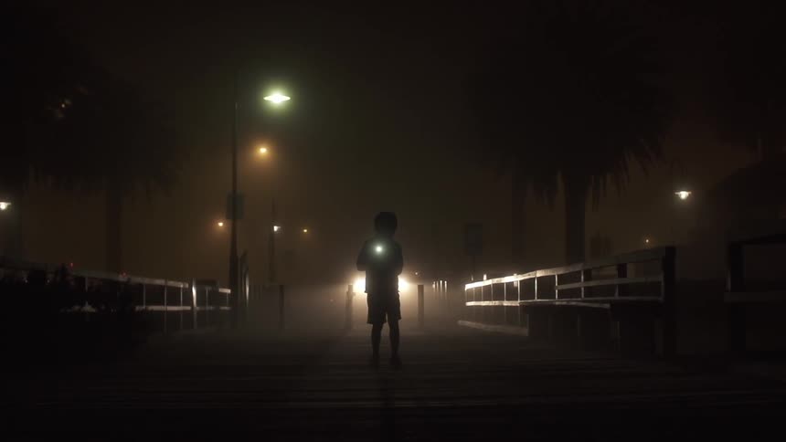 Silhouette of a child with flashlight