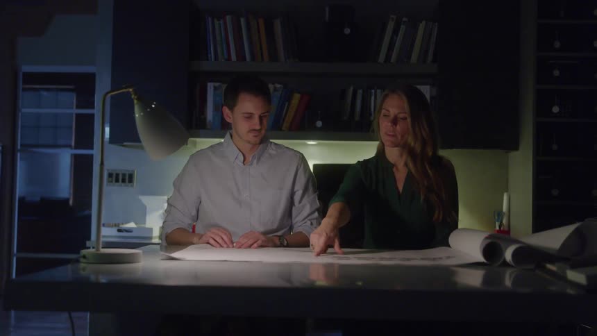 Woman and a man discussing a project at an office table