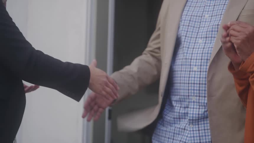 The realtor hands a couple the keys to a home
