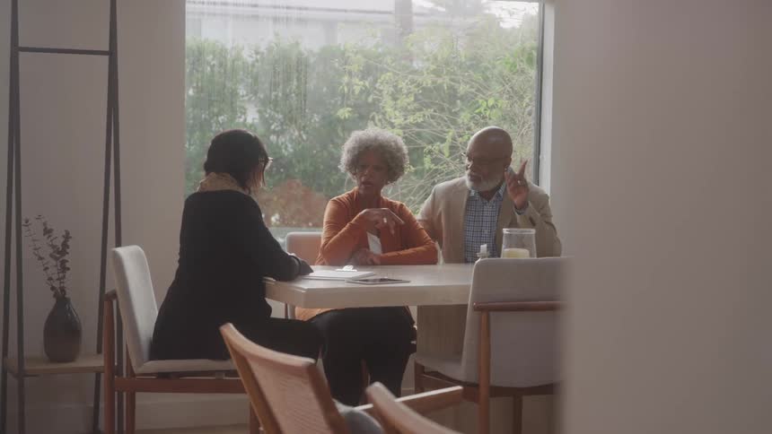 A woman is asking a couple questions and writing things down