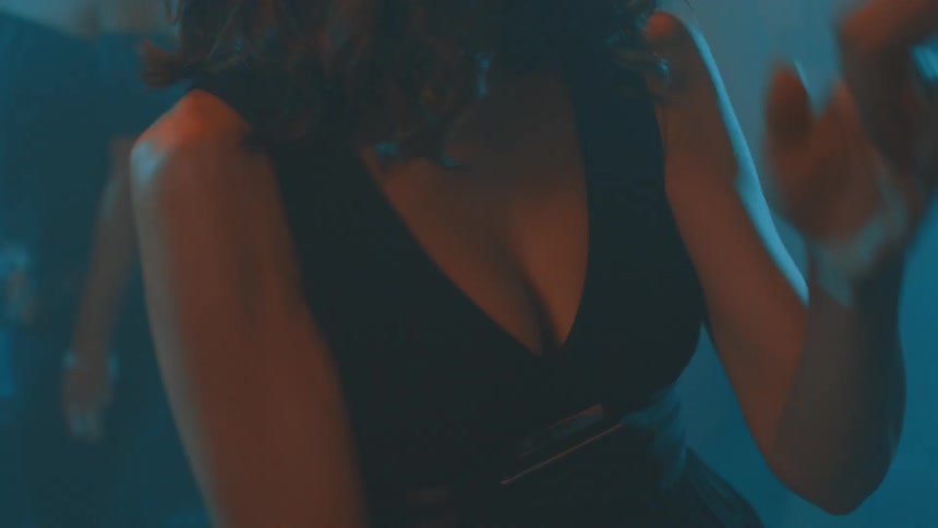 A couple dancing passionately at night in a nightclub