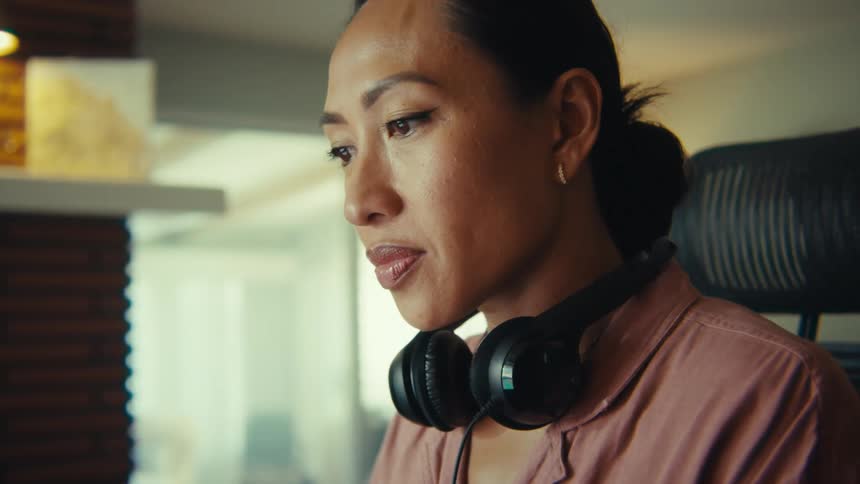 Woman sitting focused interacting with a laptop