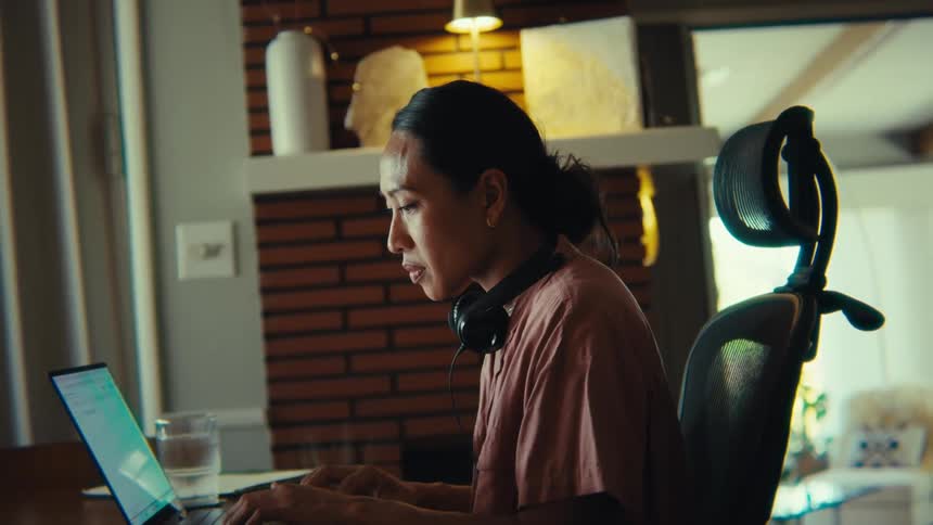 Concentrated woman typing on a laptop