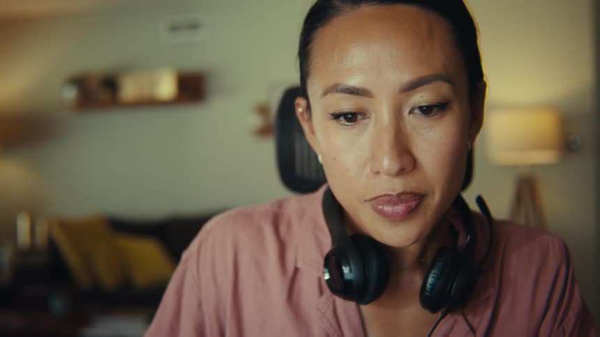 The woman wearing headphones smiles
