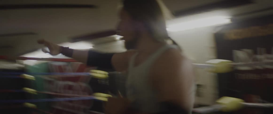 A man running inside a ring and bouncing off of the ropes