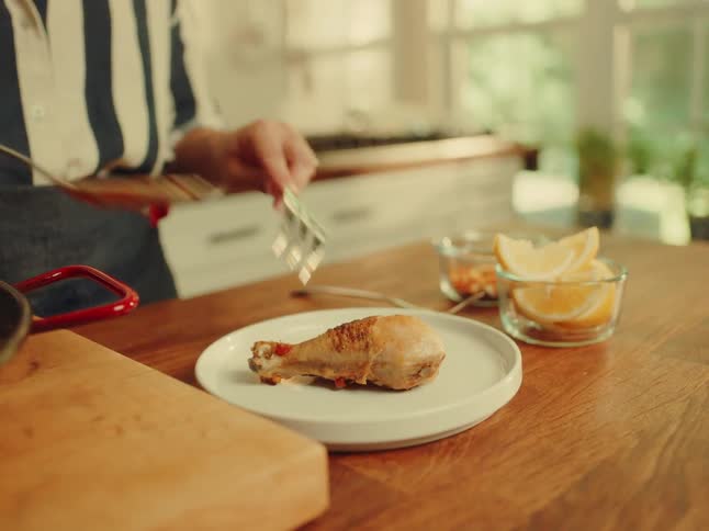 A woman plates a meal