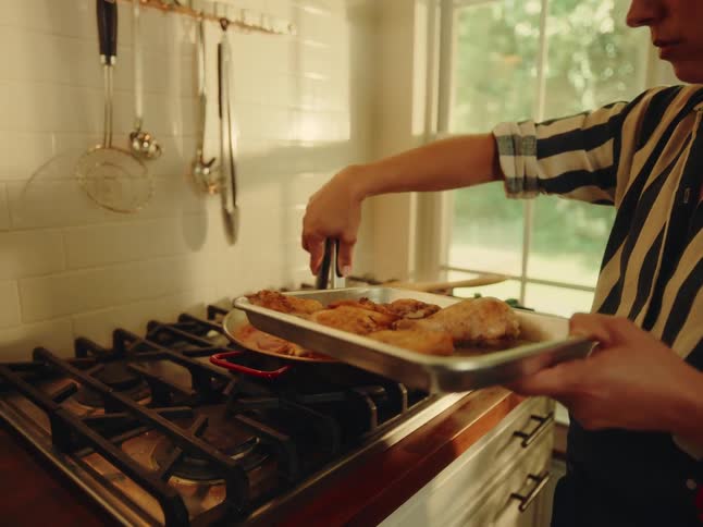 The woman is cooking a meal in the kitchen with chicken