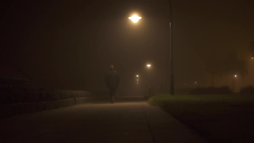 A person walking in the fog