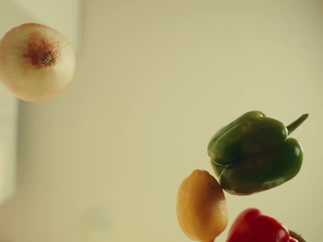 Hand picking up a vegetable on a transparent surface