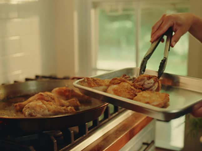 Chicken being fried in a frying pan