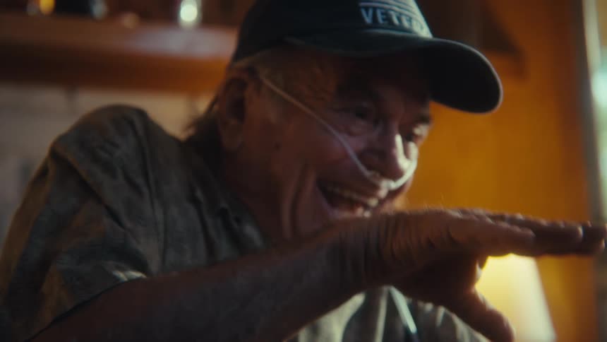 A man happily talks on his phone
