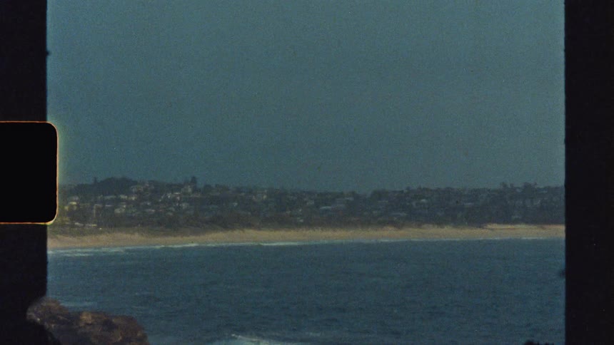 Landscape of a beach with a coastal city in the background