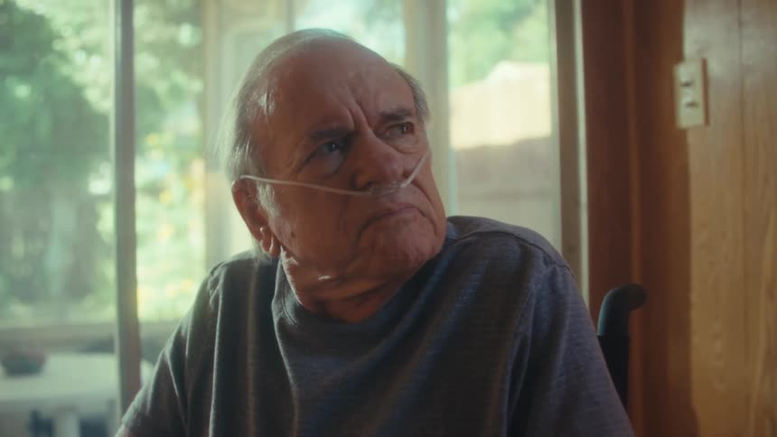 The man looks worried in his wheelchair