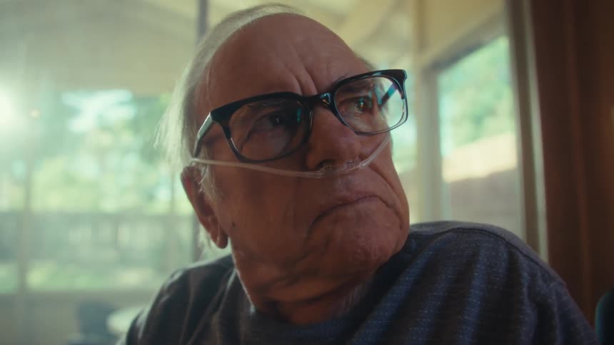 The ma takes off his glasses and frowns