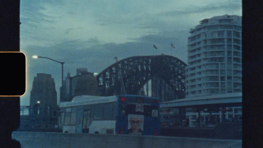 A city view on a cloudy evening seen from inside a car driving on the highway