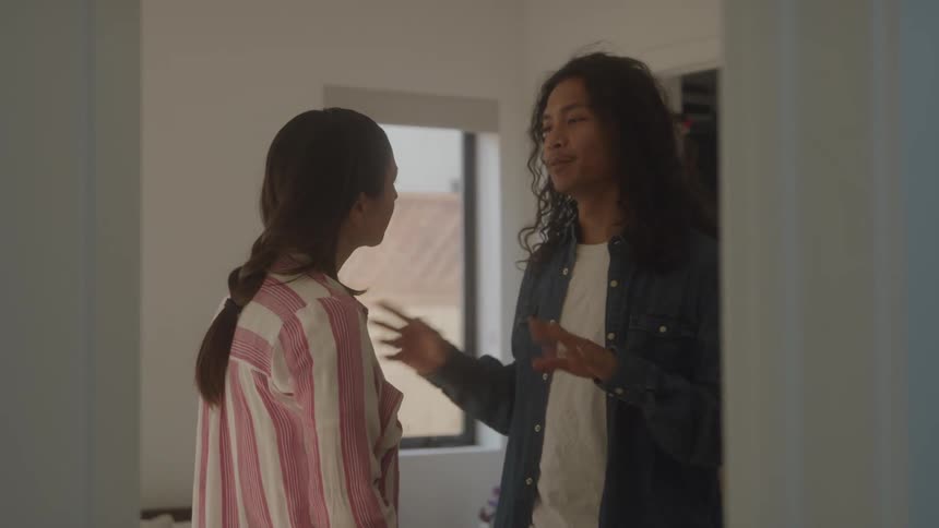 Couple talking to each other inside a room in the house