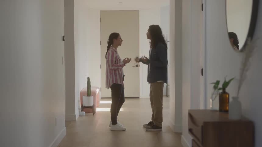 Man and a woman in a room of the house talking to each other