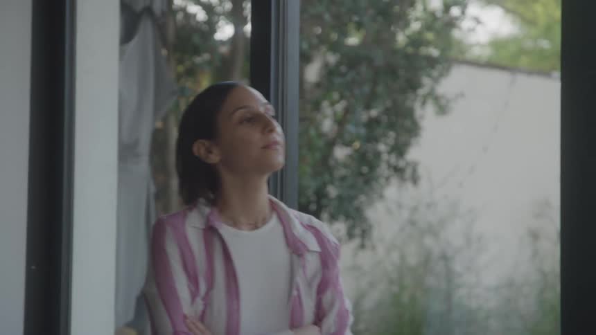 Woman walking indoors deep in thought