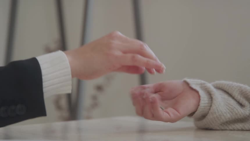 One person hands over a house key to another