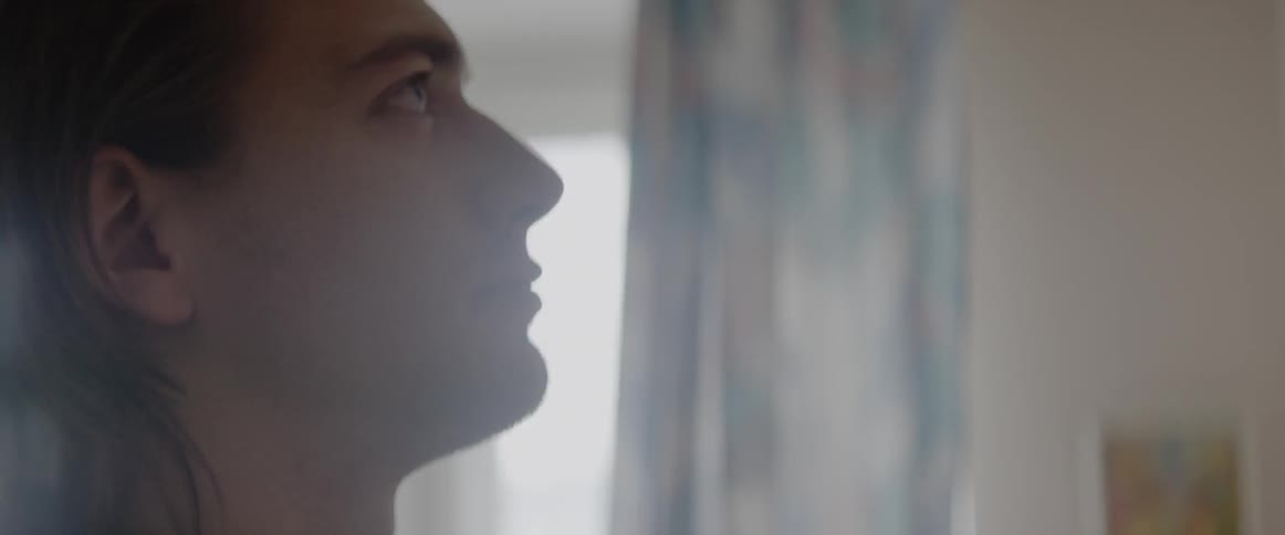 A person up close looking at something on a wall on the inside