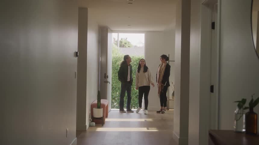 Female real estate agent showing a house to a couple